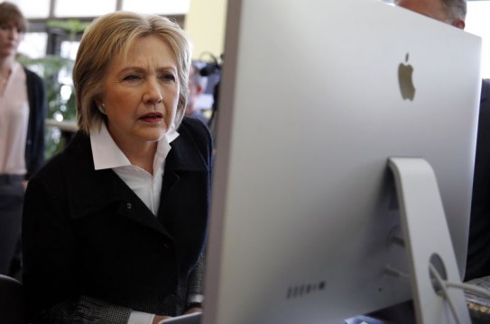 U.S. Democratic presidential candidate Hillary Clinton looks at a computer screen during a campaign stop at Atomic Object company in Grand Rapids, Michigan, U.S. March 7, 2016. REUTERS/Carlos Barria/File Photo