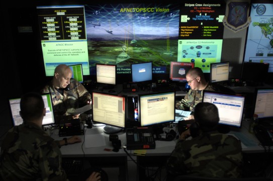 Capt. Jason Simmons and Staff Sgt. Clinton Tips update anti-virus software for Air Force units to assist in the prevention of cyberspace hackers July 12 at Barksdale Air Force Base, La. The Air Force is setting up the Air Force Cyberspace Command soon and these Airmen will be the operators on the ground floor. (U.S. Air Force photo/Tech. Sgt. Cecilio Ricardo)